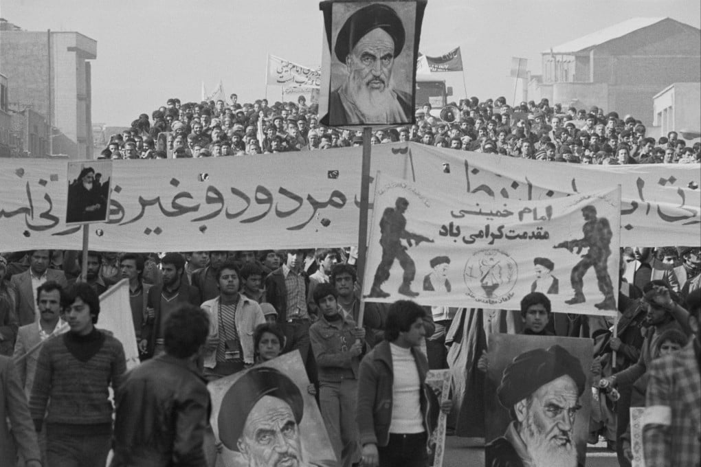 Demonstrators in Tehran carry posters of Ayatollah Khomeini and banners showing support for the provisional government of then prime minister Medhi Bazargan, during the Iranian Revolution in February 1979. Photo: Alain Dejean/Sygma/Corbis