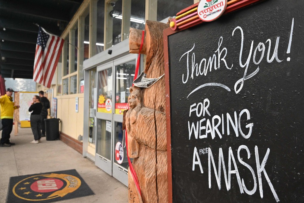A sign outside a supermarket in Indian Valley, California, thanks customers for wearing a mask, on July 27. People vaccinated against Covid-19 in high-risk parts of the US should resume wearing masks indoors, America’s top health authority said, a major shift in coronavirus guidance that underscores the country’s struggle to suppress the Delta variant. Photo: AFP