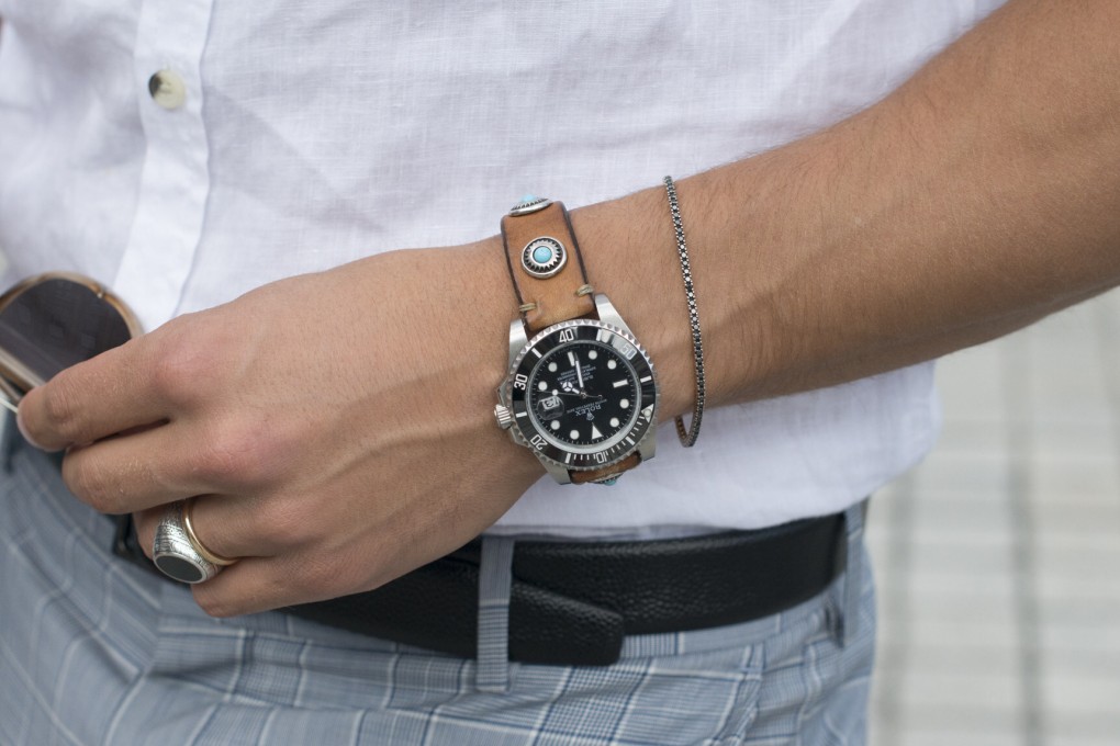 Rolex watches, like this one worn by model and fashion blogger Mariano Di Vaio, are hard to come by, but the scarcity is a strategic move by the company. Photo: Getty Images