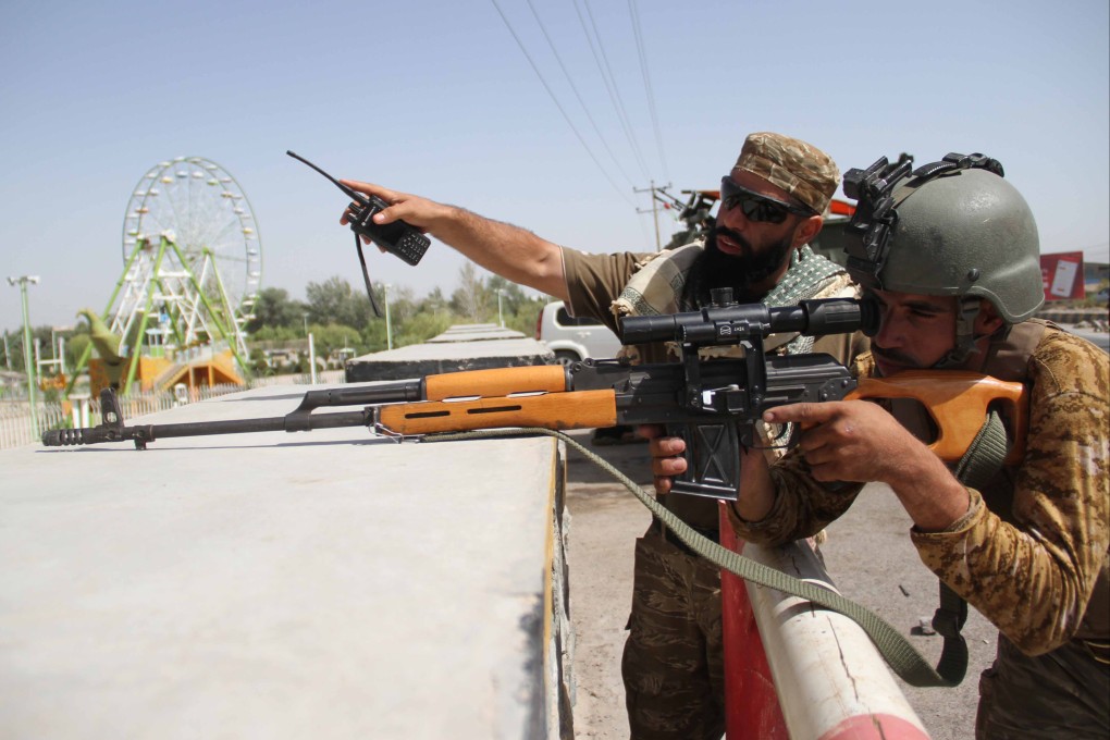 Afghan security forces stand guard at a checkpoint in Herat, Afghanistan, last month. Photo: EPA