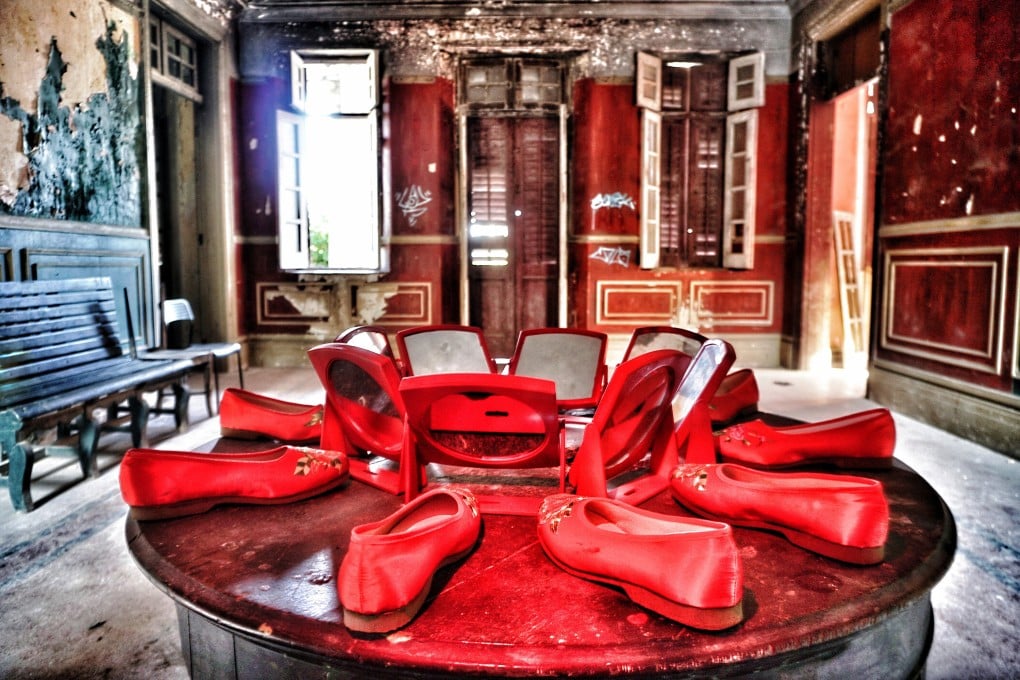Ten red embroidered shoes and eight mirrors left in formation, as if they were part of a ceremony, at a deserted English-style mansion in Hong Kong. The photo forms part of the “Vanishing Hong Kong” exhibition, to be held from August 17 to 29. Photo: P.H. Yang