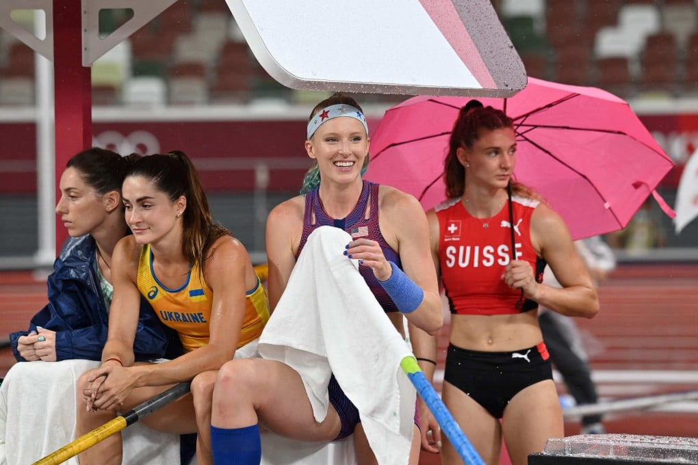 Track athletes shelter from the rain during the women’s pole vault qualification during the Tokyo 2020 Olympic Games at the Olympic Stadium in Tokyo on August 2. Women athletes should be able to wear what they feel most comfortable competing in. Photo: AFP