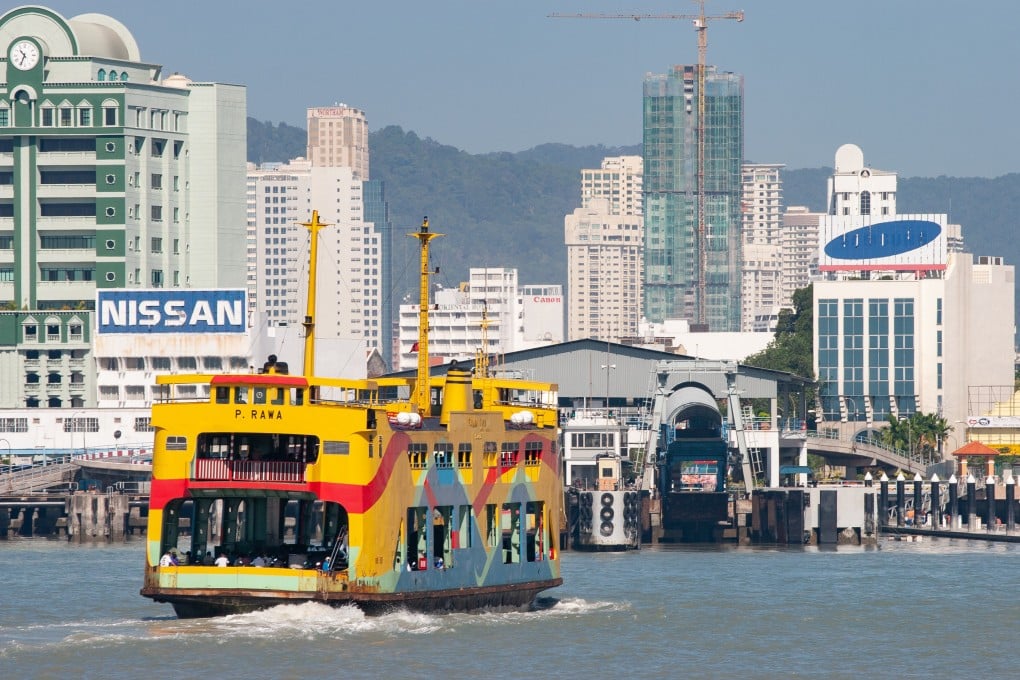 A double-decker ferry like those being preserved nears shore in Penang, Malaysia, in 2006. Ferries have sailed between the island and the mainland since the 1890s. Photo: Thum Chia Chieh