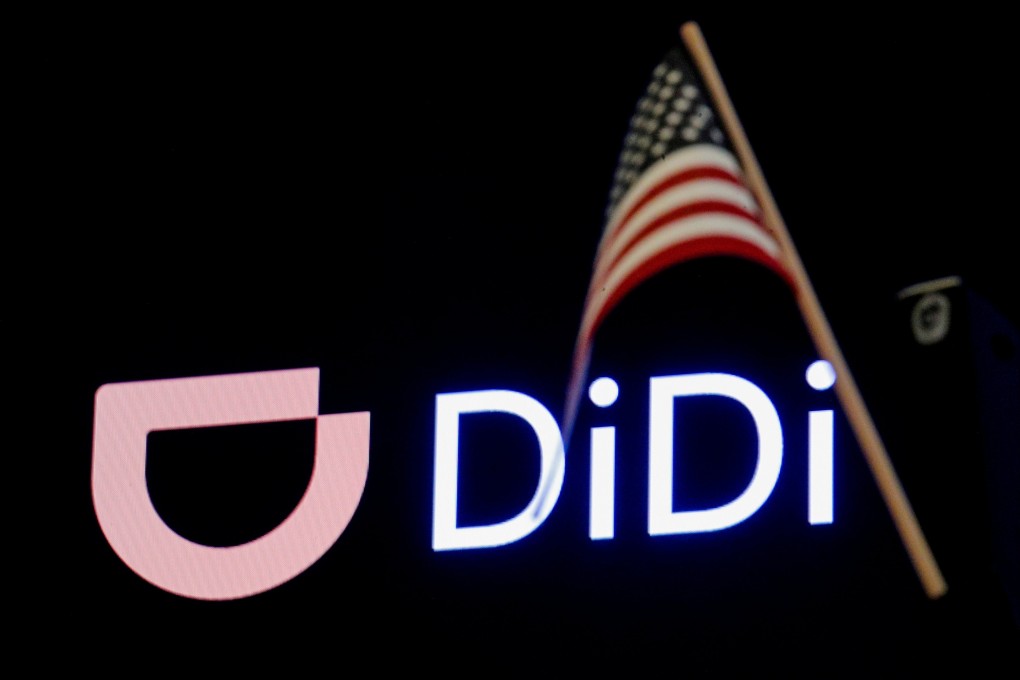 An American flag hangs in front of the logo for Chinese ride hailing company Didi Chuxing in New York on June 30. Photo: Reuters