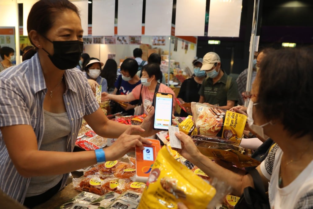 Visitors to the Hong Kong Brands and Products Shopping Expo, at Asia World Expo, make purchases with their digital shopping vouchers on August 7. Photo: Winson Wong