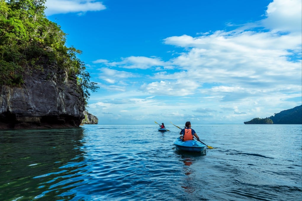 Tourists explore one of Langkawi’s many jungle-clad islands by kayak. Photo: courtesy of Dev’s Adventure Tours