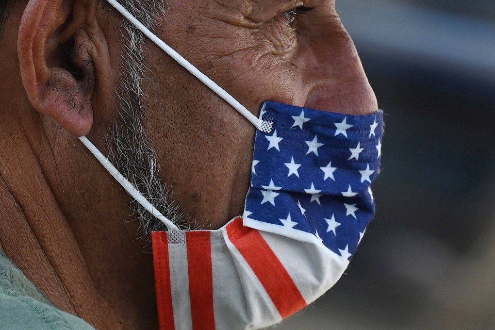 A man wears an American-flag mask in Hollywood on July 19 as an indoor mask mandate is reinstated amid a spike in coronavirus cases. Photo: AFP