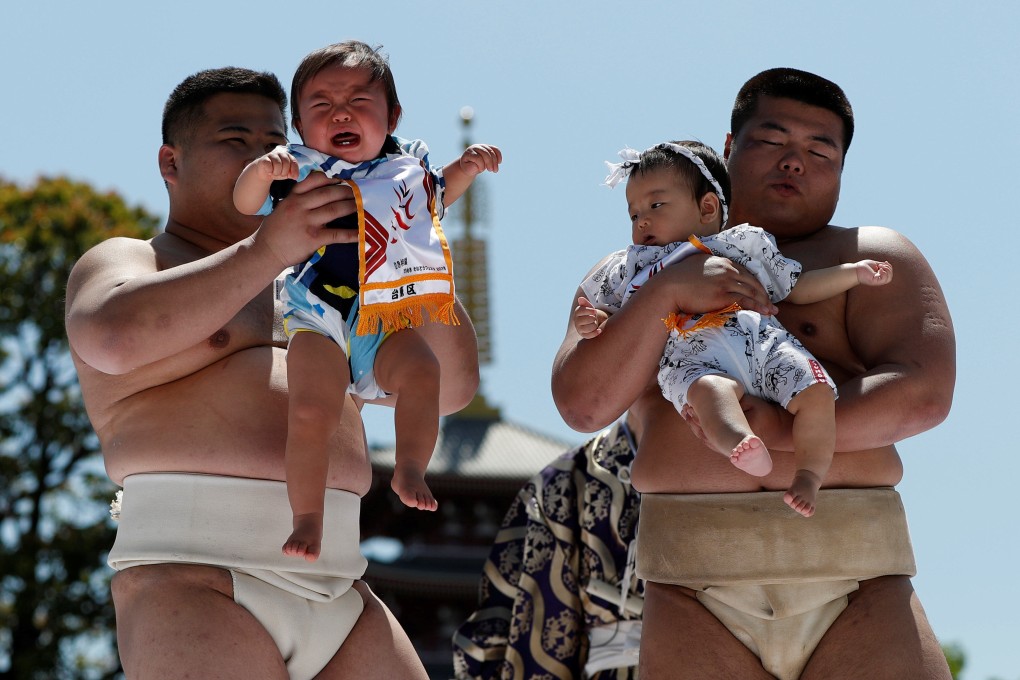 Amateur sumo wrestlers at a baby crying contest at Sensoji temple in Tokyo, Japan. Photo: Reuters