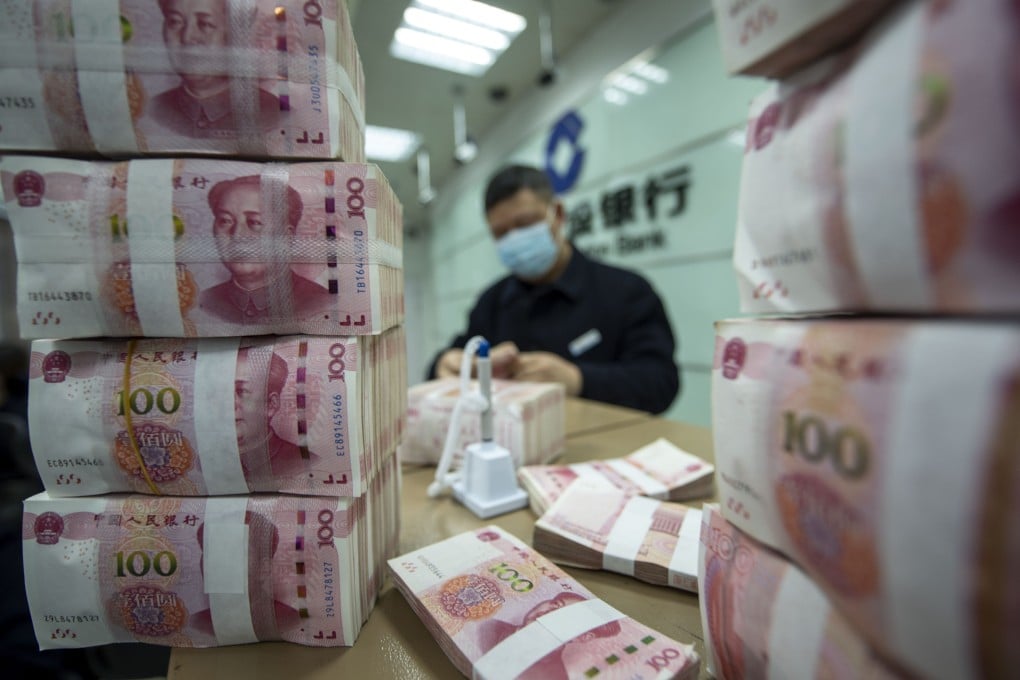 A teller counts 100 yuan bills at a bank in Nantong, eastern Jiangsu province, on February 1. Photo: Imaginechina