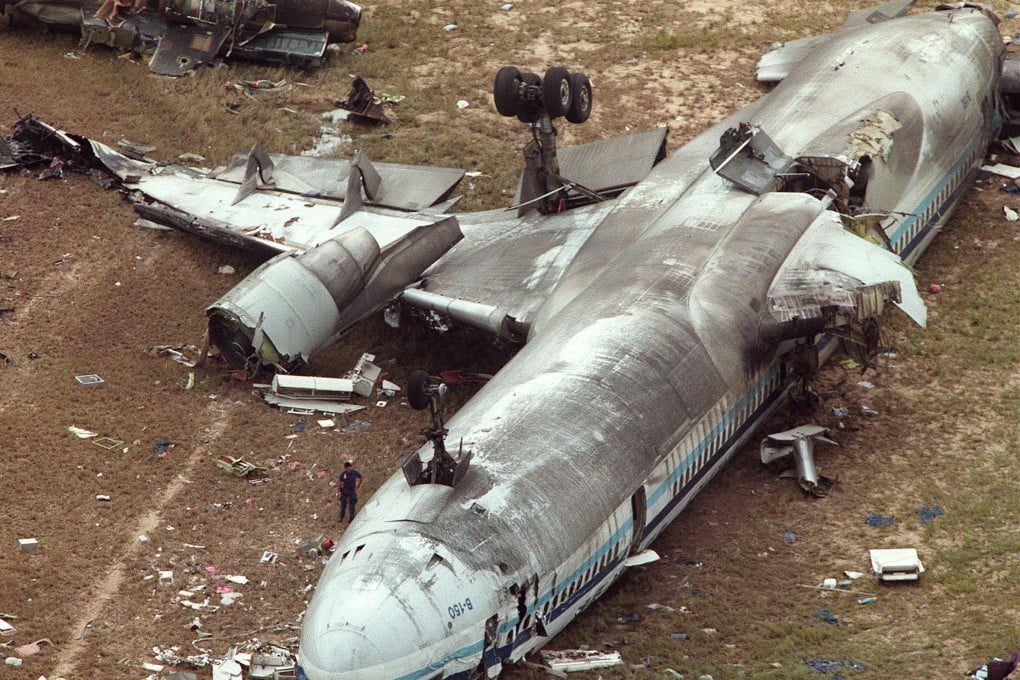 The China Airlines MD-11 lies on it back after it crash-landed in the high winds and rain of a typhoon at Hong Kong international Airport in August 1999. Photo: SCMP