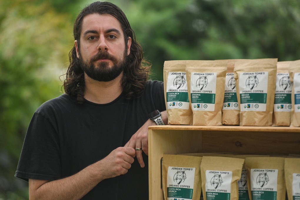 Jordan Tomb with packages of his coffee at the Bellevue Farmers Market in the US state of Washington on July 9, 2021. Photo: TNS