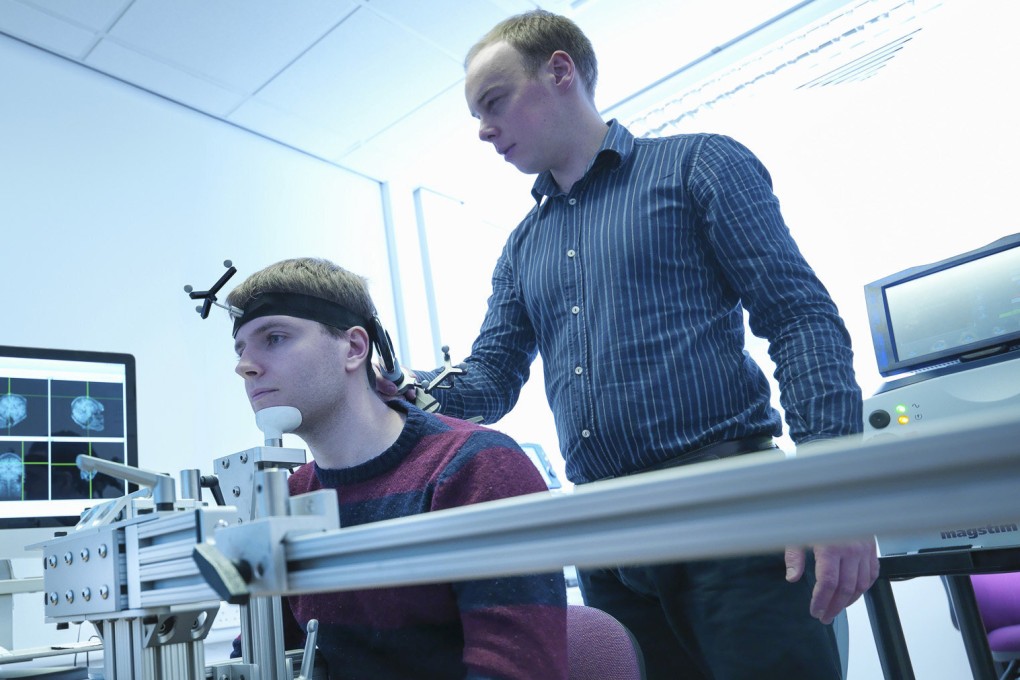 A scientist conducts a transcranial magnetic stimulation (TMS) experiment on a patient. TMS is a form of brain boosting used on people with brain injury or brain disorders, but it could boost brain performance in healthy people too, if society decides that’s a good thing, a researcher says. Photo: Shutterstock