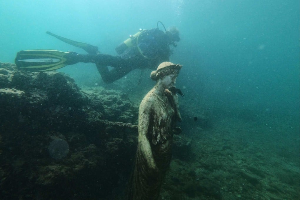 A diver swims past a replica of the statue of Antonia Minor, mother of the Emperor Claudius, at the Baiae Underwater Park in Naples, Italy. A favourite of successive emperors for its hot springs and nightlife, the city sank beneath the waves in the 5th century. Photo: AFP