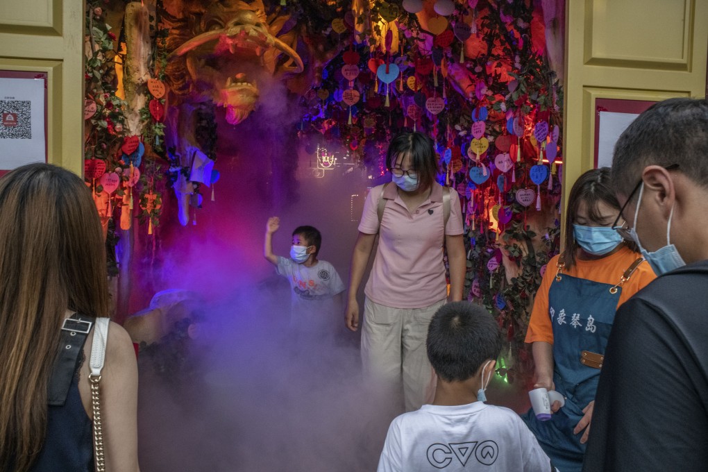 Visitors to a store in the Nanluoguxiang shopping area in Beijing have their temperature checked on August 8. The general outlook seems compatible with the Chinese economy stabilising into a 5.5 to 6.5 per cent growth range, once output volatility settles down. Photo: Bloomberg