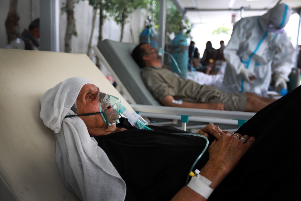 An Afghan woman breathes through an oxygen mask in a special hospital for Covid-19 patients in Kabul on June 9, 2020. Less than 2 per cent of Afghanistan’s population has received at least one vaccine dose, with only 0.5 per cent being fully vaccinated. Photo: EPA-EFE