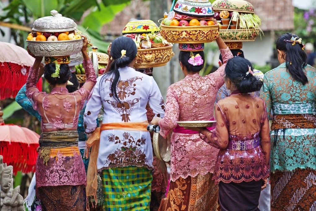 Women carry temple offerings to Pura Gunung Raung Temple near Ubud, Bali, Indonesia’s most visited island. Photo: Getty Images