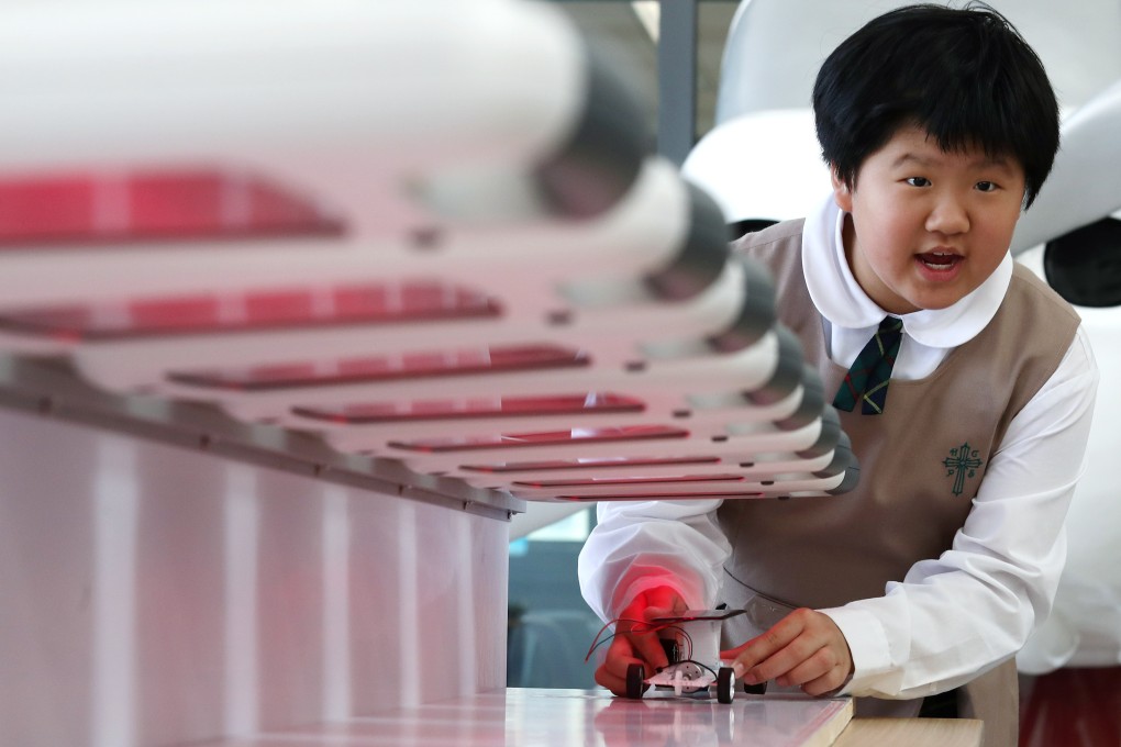 A girl experiments with a solar car during a STEM promotional activity organised by the Education Bureau at the SKH Holy Cross Primary School in Kowloon City, Hong Kong, on March 20, 2018. Photo: Nora Tam