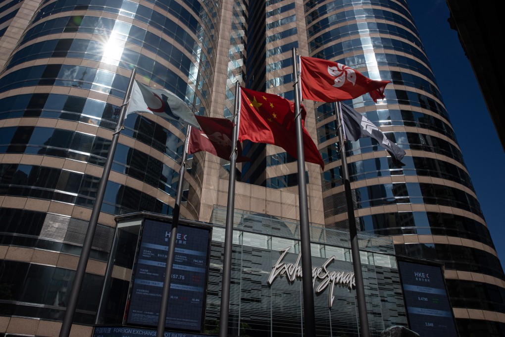 The Hang Seng Index flag (left) flies outside the Hong Kong Exchanges and Clearing building in Hong Kong on August 16, along with other flags including the national flag and Hong Kong SAR flag. Photo: EPA-EFE
