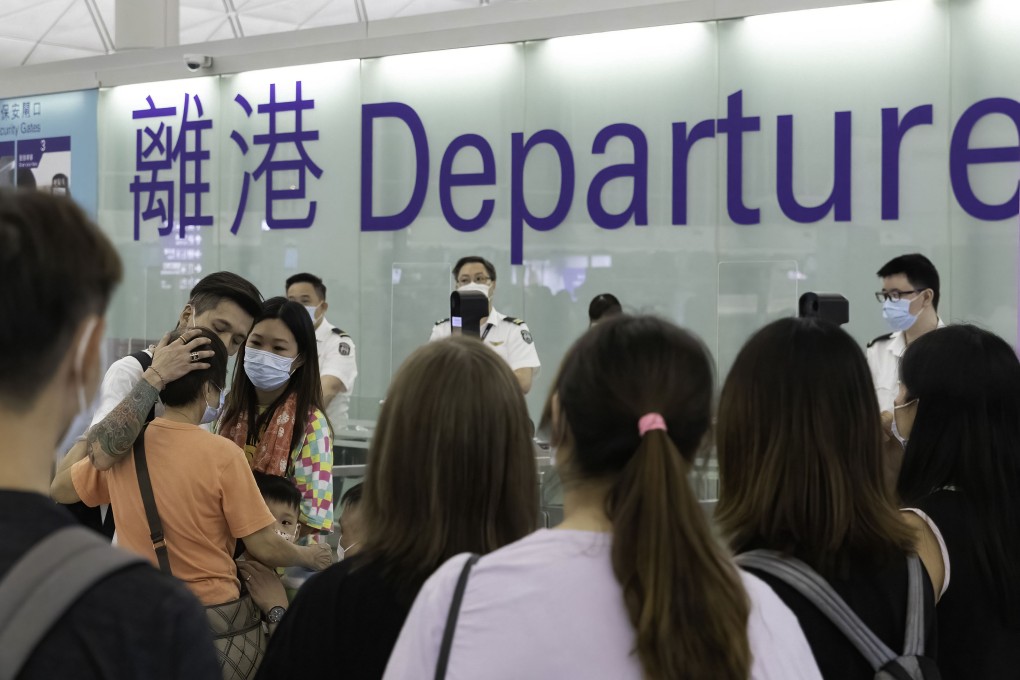 A man hugs his mother as he departs to the UK from Hong Kong with his wife this summer. Photo: Getty Images