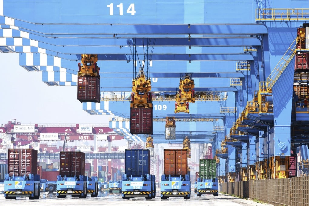 Gantry cranes move containers onto transporters at a port in Qingdao in eastern China’s Shandong province, on June 4. Photo: AP