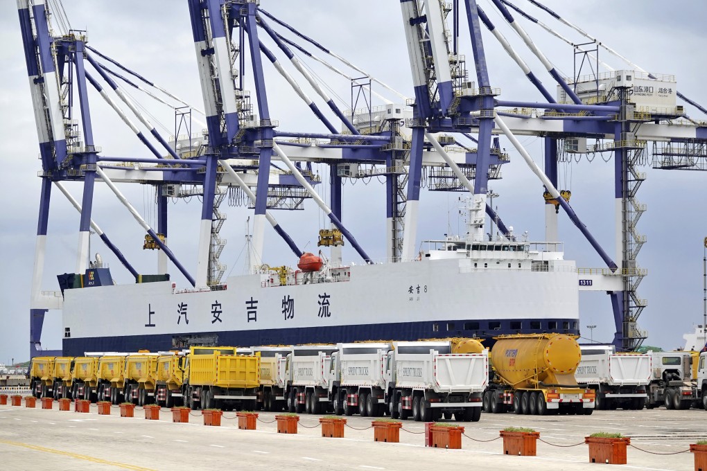 Trucks ready for export are lined up at a cargo port in Yantai in China’s Shandong province on July 30. China’s astonishing achievement in international trade and investment over the past three decades has been a resounding success story of globalisation. Photo: Chinatopix via AP