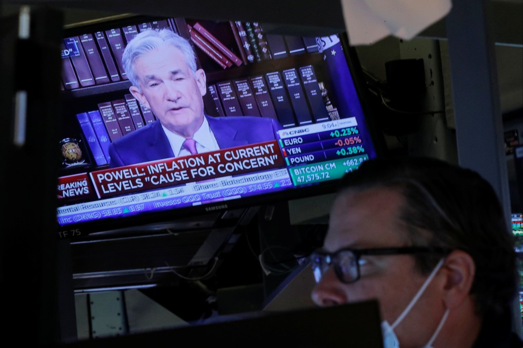 A screen shows US Federal Reserve chair Jerome Powell speaking as a trader works on the floor of the New York Stock Exchange on August 27. Photo: Reuters