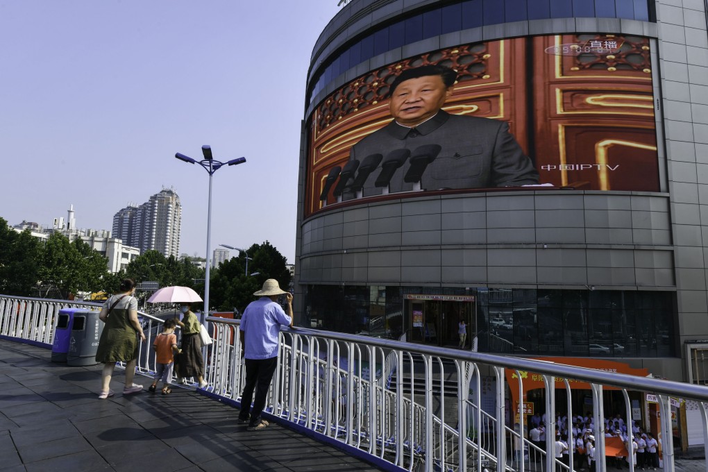 A giant screen on Renmin Road in Fuyang, shows Chinese President Xi Jinping giving a speech. Photo: Getty Images