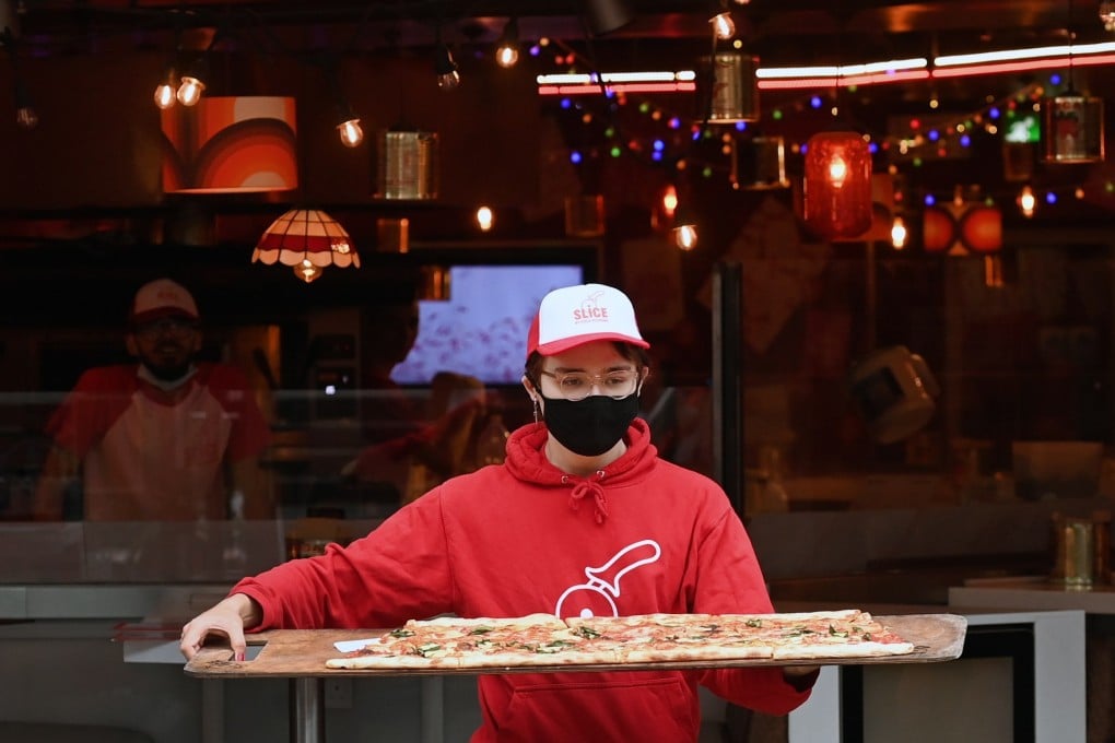 Staff at a pizza restaurant in London, Britain, working on August 17. Of the millions of jobs that were lost or suspended through the past 18 months, how many will return and how many are lost forever? Photo: EPA-EFE