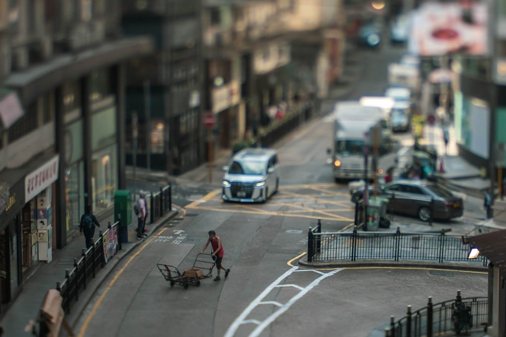 An image of a trolley pusher crossing Hollywood Road in Central, shot by Anthony Lau as part of Designing Hong Kong’s exhibition Walking With Wheels at Ping Pong 129 Gintoneria in Sai Ying Pun. Photo: Designing Hong Kong/Anthony Lau