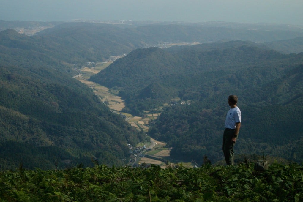 A walker looks out over the Kunisaki Peninsula, an area of steep-sided ridges whose tops give views to the kind of farmland Walk Japan is helping to rehabilitate. Photo: Peter Neville-Hadley