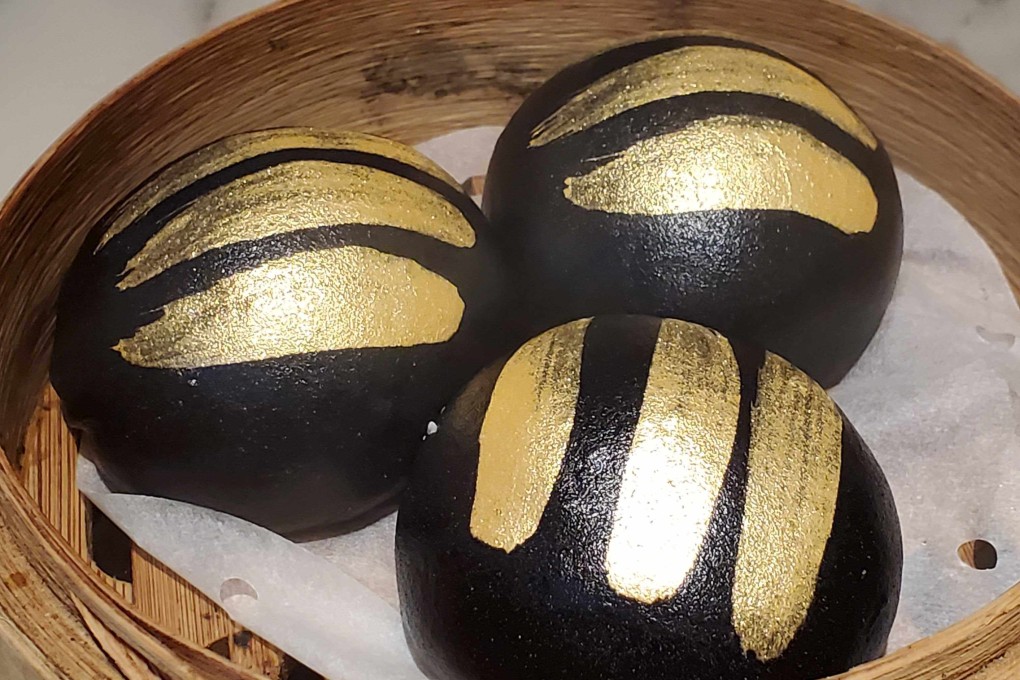 Charcoal custard buns with gold brushed over the top at modern dim sum restaurant Social Place in Central, Hong Kong. Photo: Ginny Wong