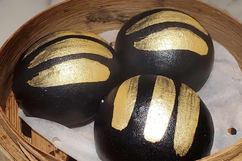 Charcoal custard buns with gold brushed over the top at modern dim sum restaurant Social Place in Central, Hong Kong. Photo: Ginny Wong