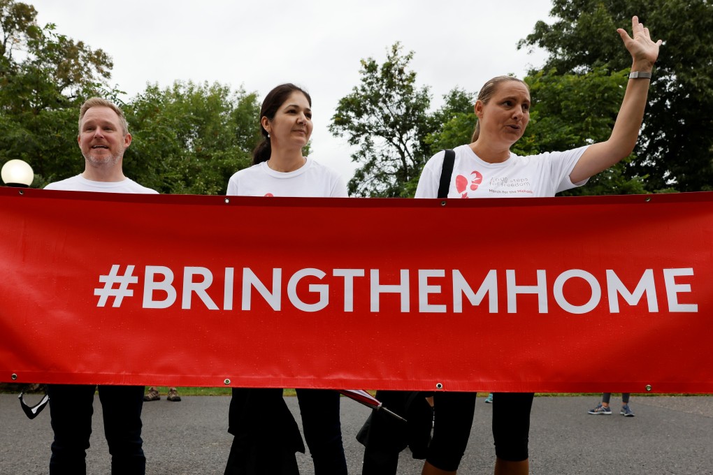 (From the left) Paul Spavor, Michael Spavor’s brother, Vina Nadjibulla, Michael Kovrig’s wife, and Ariana Botha, Kovrig’s sister, thank supporters after a march to mark 1,000 days since the two men were arrested in China, during a protest in Ottawa, Ontario, Canada on September 5. Photo: Reuters