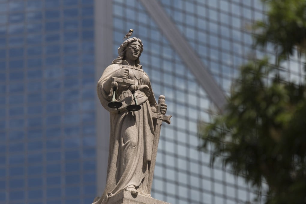 A statue of Lady Justice sits atop the Court of Final Appeal building in Central, Hong Kong, on July 4, 2018. Photo: EPA-EFE