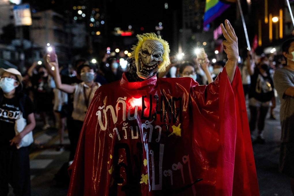 A protester wearing a mask gives a three finger salute during a demonstration calling for the resignation of Thailand’s Prime Minister Prayut Chan-Ocha over the government’s handling of the Covid-19 pandemic. Photo: AFP