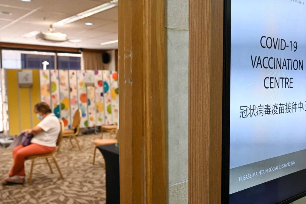A woman waits to be vaccinated in Singapore. The vaccination rate rose after the government announced segregration measures against the unvaccinated, but some people felt they had been pressured to get jabbed, and others still hold out. Photo: AFP