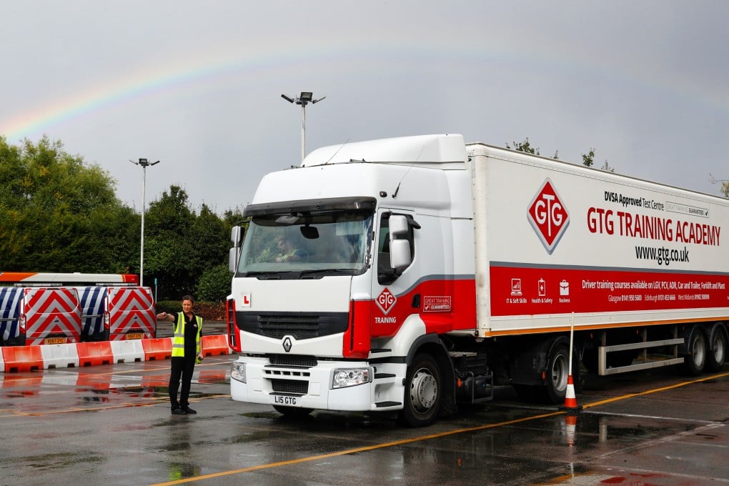 A heavy goods vehicle driving instructor directs a student in Wolverhampton, Britain. Photo: Bloomberg