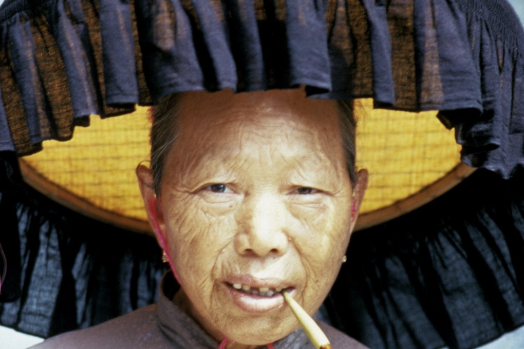 A woman wears a flat, fringed Hakka farmer’s hat. Practicality trumped fashion when it came to choosing hats in Hong Kong,  until the advent of the baseball cap, adopted to mimic Japanese who wore them to appear American. Photo: Getty Images