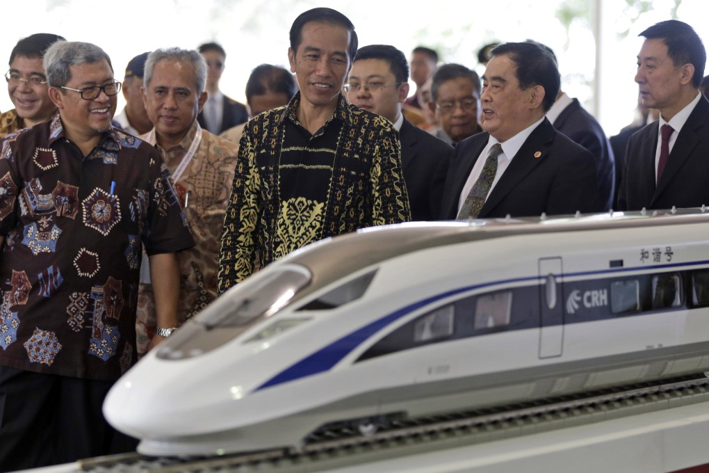 Indonesian President Joko Widodo looks at a model of a high-speed train which will connect Jakarta to Bandung. File photo: AP