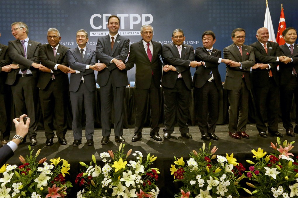 Ministers from member states of the Comprehensive and Progressive Agreement for Trans-Pacific Partnership link hands after signing the agreement in Santiago, Chile, on March 8, 2018. Photo:AP
