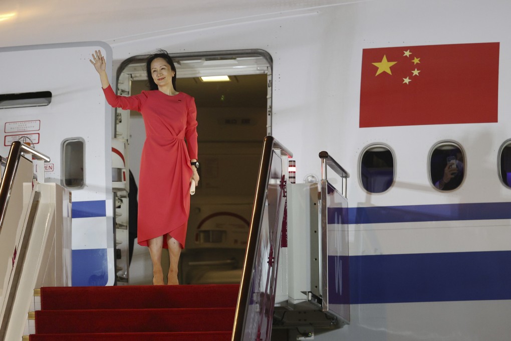 Meng Wanzhou waves at a cheering crowd as she steps out of a charter plane at Shenzhen Bao’an International Airport on September 25. Photo: Xinhua