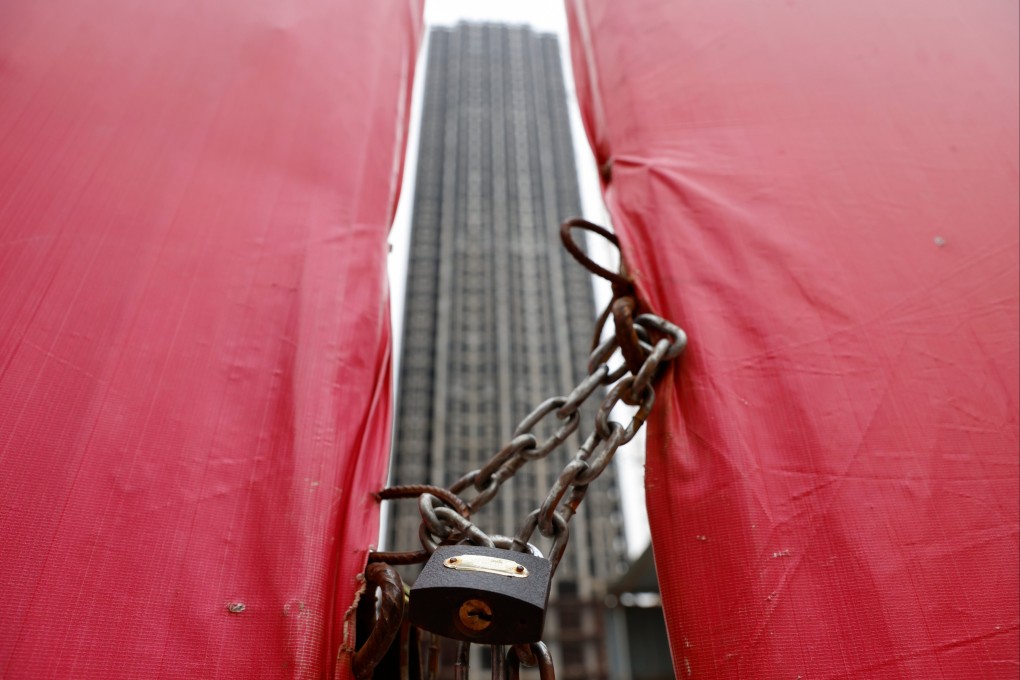 An unfinished residential building is pictured through a construction site gate at Evergrande Oasis, a housing complex developed by Evergrande Group, in Luoyang, Henan province, on September 16. Photo: Reuters