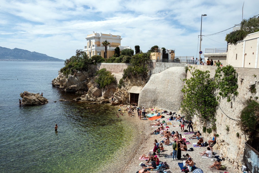 Sunbathers relax on Maldorme beach in the Endoume district in Marseille, France, on April 25. How long do Hong Kong leaders want to restrict Hongkongers’ freedom to travel? Photo: Bloomberg