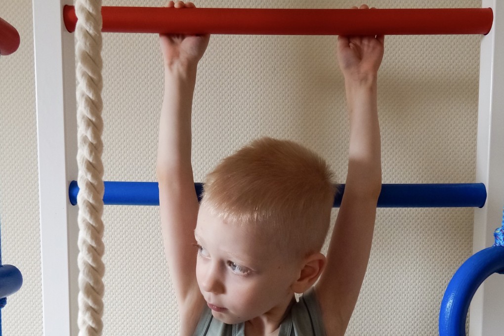 A boy hangs from a bar in a children’s gym. Internationally, children’s fitness levels have been in decline for two decades, except for grip strength, research shows.
Photo: Getty Images