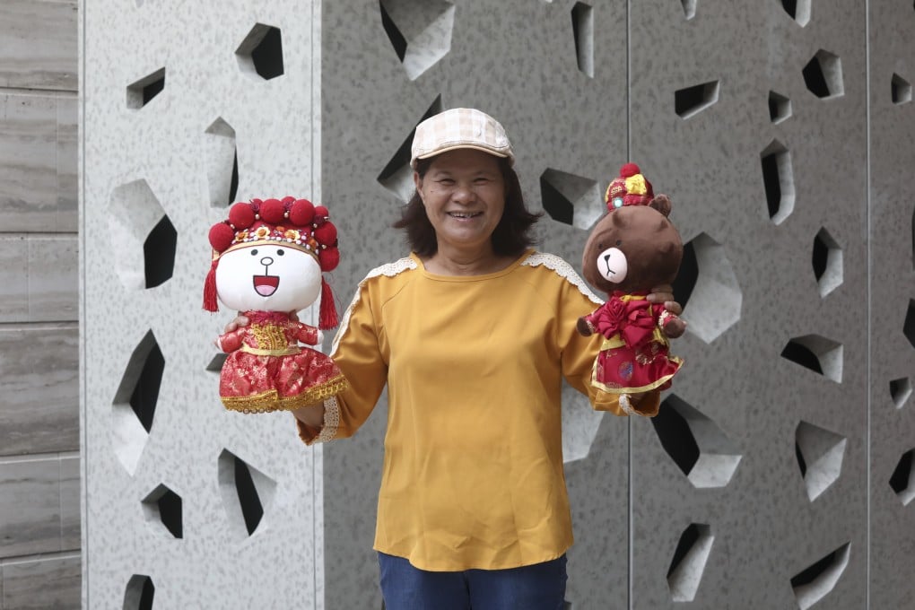 Wedding doll dress maker Irene Law Oi-ling with examples of her work. It used to take her a week to make a suit and gown for wedding dolls when she started in the business 12 years ago; now she can make a wedding dress or suit in a day. Photo: Jonathan Wong