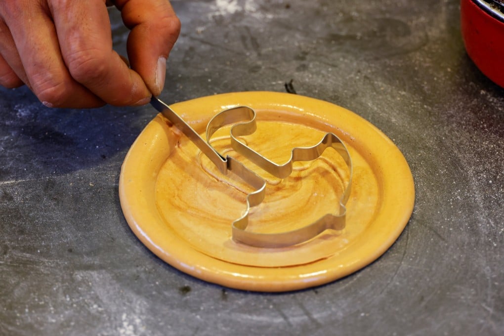 A street vendor sells dalgona from the Korean Netflix series Squid Game in Seoul, South Korea. One of the challenges in the show involves a piece of this confectionery. Photo: Reuters