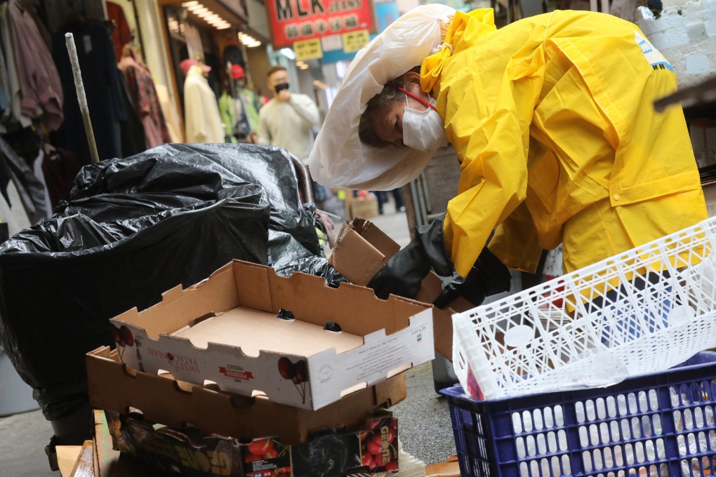 An elderly woman collects cardboard boxes on a street in Mong Kok in February 2020. It is no longer acceptable to protect businesses while allowing those who have worked hard their entire lives, but still do not have a basic standard of living, to continue to suffer. Photo: K. Y. Cheng