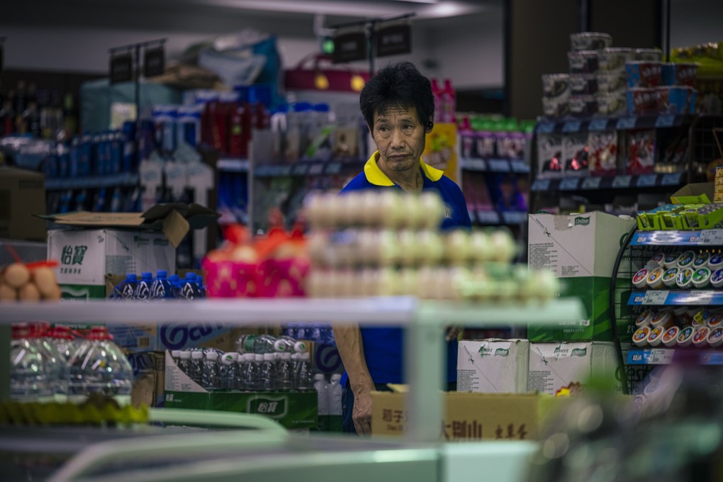 A man stands in a store in Shanghai, China, on July 9. Asia’s emerging markets have proved relatively resilient in the face of the intensifying inflationary pressures and sharp slowdowns that have posed policy dilemmas for central banks in other parts of the world. Photo: EPA-EFE