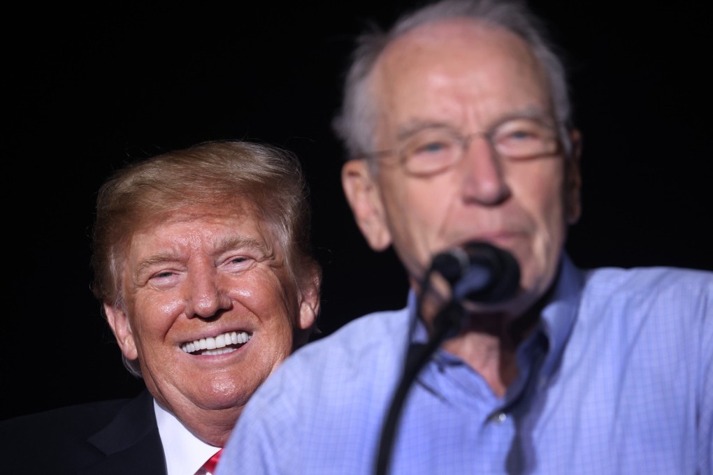 Former president Donald Trump smiles as Senator Chuck Grassley speaks during a rally at the Iowa State Fairgrounds on October 9. Photo: AFP