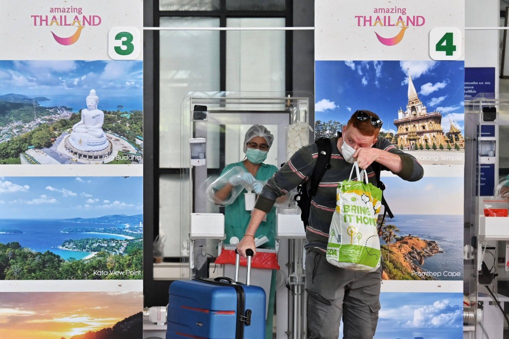 An international passenger leaves Phuket airport after a medical worker gave him a Covid-19 coronavirus swab test as part of the Sandbox scheme. Photo: AFP